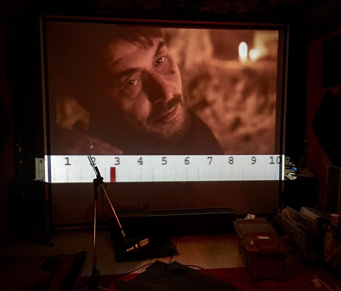 Recording session: close-up on screen, microphone on a stand